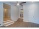 Living area with modern flooring, white walls, and steps leading to another living space and kitchen at 1261 Hampshire Rd, Charleston, SC 29412