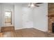 Living space featuring vinyl flooring, fireplace with brick accents, and an entry leading to the kitchen at 1261 Hampshire Rd, Charleston, SC 29412