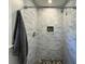 Modern walk-in shower with subway tile, a river rock floor, and a built-in niche at 1261 Hampshire Rd, Charleston, SC 29412