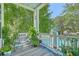 Relaxing back porch with a bench, plants, rooster decor, and a view of a tranquil waterway at 129 Howard Mary Dr # A, Charleston, SC 29412