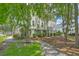 Exterior view of a three-story home with a landscaped yard and mature trees at 129 Howard Mary Dr # A, Charleston, SC 29412