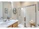 Clean bathroom with a glass-enclosed shower, neutral tones, and decorative seashell wreath at 129 Howard Mary Dr # A, Charleston, SC 29412