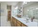 Bright bathroom with double sinks, white countertops, and access to a walk-in closet at 129 Howard Mary Dr # A, Charleston, SC 29412