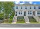 Charming townhomes featuring symmetrical white exteriors, inviting stairs, and lush landscaping at 129 Howard Mary Dr # A, Charleston, SC 29412