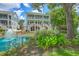 Back exterior view of a three-story house, fountain, and well-manicured backyard at 129 Howard Mary Dr # A, Charleston, SC 29412