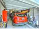 Attached garage with an orange SUV, surfboard, and ample storage space at 129 Howard Mary Dr # A, Charleston, SC 29412