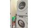 Convenient laundry room featuring a stacked washer and dryer, plus a shelf with laundry supplies at 129 Howard Mary Dr # A, Charleston, SC 29412