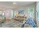 Spacious living room with views into the kitchen, a stylish rug, and comfortable leather seating at 129 Howard Mary Dr # A, Charleston, SC 29412