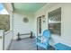 Charming porch features a blue ceiling, beach decor, a comfortable Adirondack chair with a cushion, and relaxing accents at 129 Howard Mary Dr # A, Charleston, SC 29412