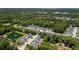 Aerial view of a charming neighborhood featuring a pond and well-maintained homes surrounded by lush trees at 1300 Enfield Ln, Mount Pleasant, SC 29466