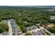 An aerial view of a neighborhood surrounded by lush trees and a view of the water in the distance at 1300 Enfield Ln, Mount Pleasant, SC 29466