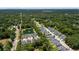 Aerial view of a charming neighborhood featuring a pond and well-maintained homes surrounded by lush trees at 1300 Enfield Ln, Mount Pleasant, SC 29466