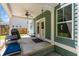 Cozy back porch with a ceiling fan, neutral green paint, furniture, and adjacent to the fenced-in backyard at 1300 Enfield Ln, Mount Pleasant, SC 29466