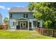Exterior of home showcasing a fenced-in yard, covered porch, green paint, and several windows at 1300 Enfield Ln, Mount Pleasant, SC 29466