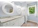 Bright bathroom featuring double vanity with granite countertops and round mirrors at 1300 Enfield Ln, Mount Pleasant, SC 29466