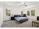 Bright bedroom featuring gray carpet, ceiling fan and a queen bed, lit by windows at 1300 Enfield Ln, Mount Pleasant, SC 29466