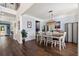 Bright dining room with dark wood floors, modern light fixture and large windows providing natural light at 1300 Enfield Ln, Mount Pleasant, SC 29466