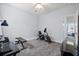Carpeted exercise room featuring workout equipment, a ceiling fan, and entry to an adjacent room at 1300 Enfield Ln, Mount Pleasant, SC 29466