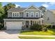 Charming two-story home features an attached garage, manicured lawn, and welcoming front porch at 1300 Enfield Ln, Mount Pleasant, SC 29466