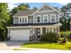 Charming two-story home with a well-manicured lawn, two car garage, and inviting front porch with beautiful landscaping at 1300 Enfield Ln, Mount Pleasant, SC 29466
