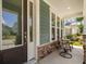 Covered front porch featuring stone pillars and a comfortable seating area at 1300 Enfield Ln, Mount Pleasant, SC 29466