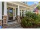 Charming front porch with stone accents, a seating area, and lush landscaping at 1300 Enfield Ln, Mount Pleasant, SC 29466