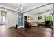 Open-concept living room with dark wood floors, large windows and comfortable seating at 1300 Enfield Ln, Mount Pleasant, SC 29466