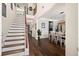 Open floor plan with hardwood floors leading to a dining area and staircase to the upper level at 1300 Enfield Ln, Mount Pleasant, SC 29466