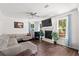 Bright living room with a fireplace, large windows, and comfortable sectional sofa at 1300 Enfield Ln, Mount Pleasant, SC 29466