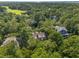 Aerial view showcasing a home, mature trees, and a nearby golf course in a beautiful, serene setting at 132 Turnberry Dr, Johns Island, SC 29455