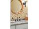 Bathroom with yellow patterned wallpaper, rattan mirror and black faucet at 132 Turnberry Dr, Johns Island, SC 29455
