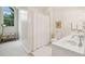 Bright bathroom featuring a large arched window, white vanity, and white shower curtain at 132 Turnberry Dr, Johns Island, SC 29455