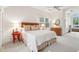 Inviting bedroom with large windows, neutral carpet, bed with patterned bedding, and white walls at 132 Turnberry Dr, Johns Island, SC 29455