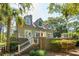 Home exterior showcasing a deck, stairs, neutral siding, manicured landscaping, and an American flag at 132 Turnberry Dr, Johns Island, SC 29455