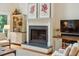 Living room fireplace, flanked by decorative cabinets, and television at 132 Turnberry Dr, Johns Island, SC 29455