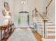Welcoming foyer with staircase, console table, and arched doorway to the outside at 132 Turnberry Dr, Johns Island, SC 29455