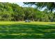 Scenic golf course with lush green fairways, golf carts, and a distant golfer enjoying a sunny day at 132 Turnberry Dr, Johns Island, SC 29455