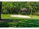 Picture of a golf course fairway with a sand trap and home in the background at 132 Turnberry Dr, Johns Island, SC 29455