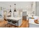 Open-concept kitchen featuring an island with seating, modern lighting, and stainless steel appliances at 132 Turnberry Dr, Johns Island, SC 29455