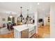 Open-concept kitchen with a large island, modern appliances, and a view of the dining and living areas at 132 Turnberry Dr, Johns Island, SC 29455