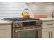 Modern range with stainless steel features and white cabinetry in the kitchen at 132 Turnberry Dr, Johns Island, SC 29455