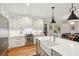 Modern kitchen with stainless steel appliances, white cabinets, and an island with marble countertops at 132 Turnberry Dr, Johns Island, SC 29455