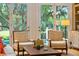 Comfortable sitting area with view of pool and lush greenery beyond French doors at 132 Turnberry Dr, Johns Island, SC 29455
