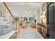 Bright living room with skylight, hardwood floors, fireplace, and french doors leading to the backyard at 132 Turnberry Dr, Johns Island, SC 29455