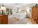 Cozy main bedroom features a white quilt, ceiling fan and a set of french doors at 132 Turnberry Dr, Johns Island, SC 29455