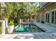 Backyard pool area is surrounded by a deck, seating, an American flag, and a beautiful yard at 132 Turnberry Dr, Johns Island, SC 29455