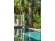 Close up of the in-ground pool, showing the water and the nearby tropical foliage at 132 Turnberry Dr, Johns Island, SC 29455