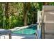 A closer look at the in-ground pool, featuring a cool deck, lush trees, and a lounge chair at 132 Turnberry Dr, Johns Island, SC 29455