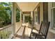 Spacious porch with rocking chairs, offering a tranquil outdoor space with nature views at 132 Turnberry Dr, Johns Island, SC 29455