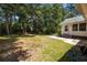 Backyard featuring well-maintained lawn, patio area, and partial house view at 133 Bramwell Dr, Summerville, SC 29485